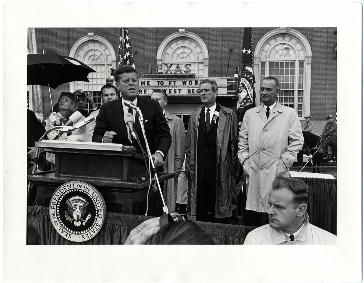 A Photo Taken on the Day of His Death: President Kennedy, Flanked by Vice-President Johnson, Gives a Speech in the Rain