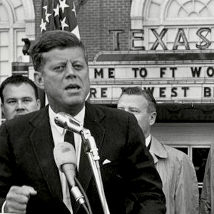A Photo Taken on the Day of His Death: President Kennedy, Flanked by Vice-President Johnson, Gives a Speech in the Rain
